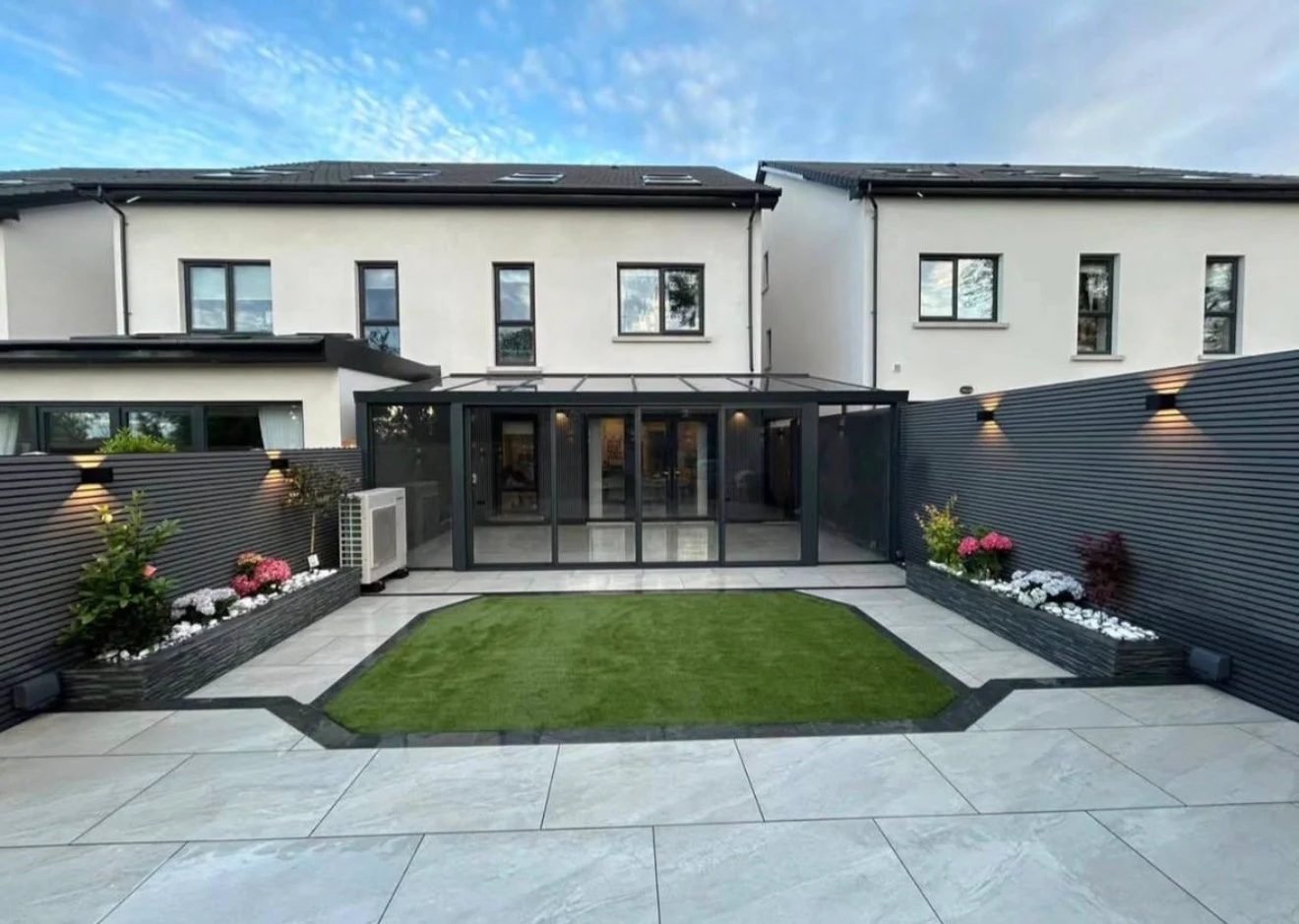 Contemporary garden with porcelain paving and artificial lawn