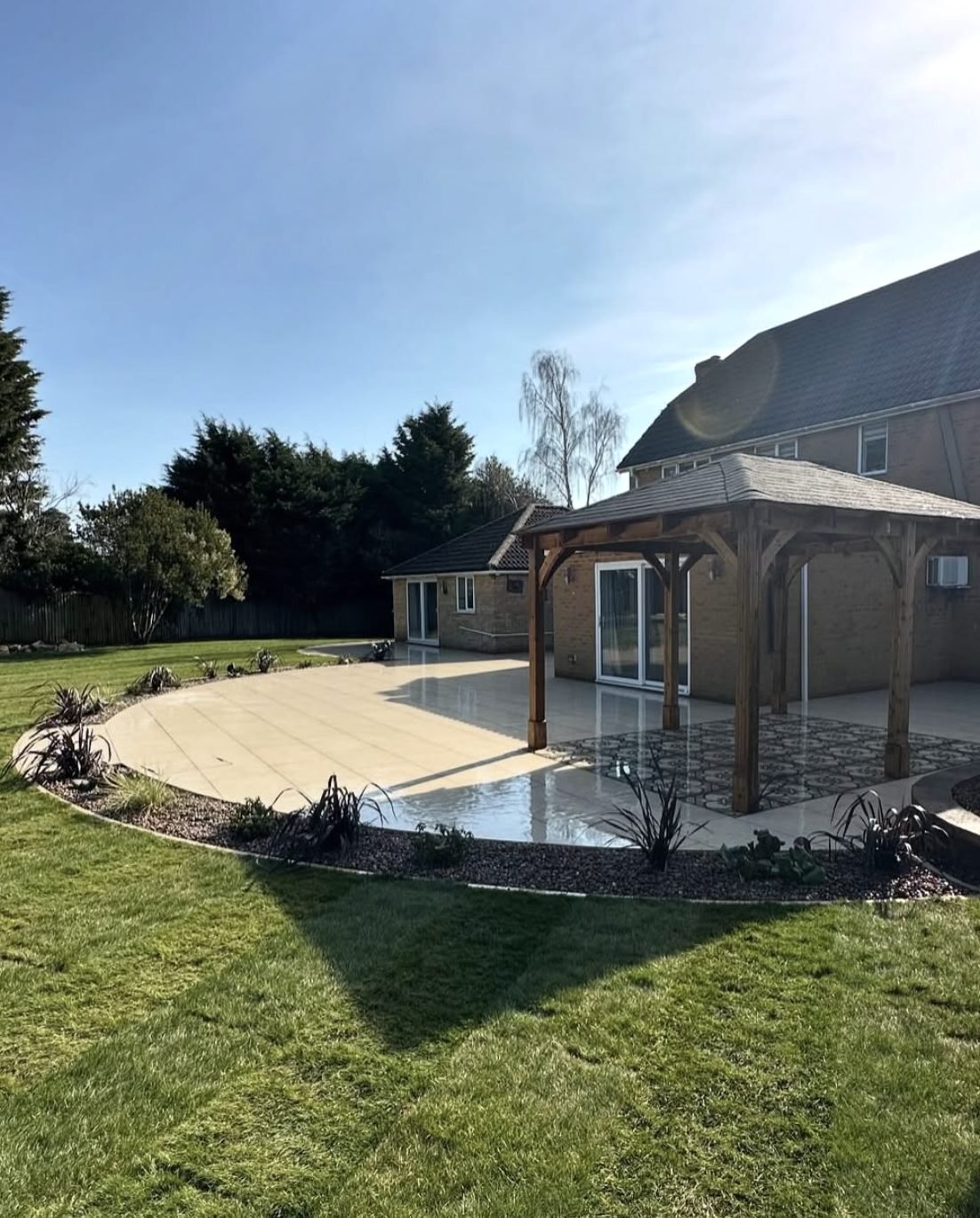 Large curved porcelain patio with oak gazebo
